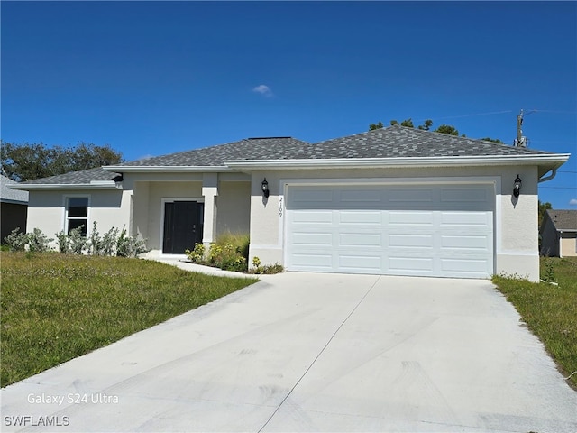 view of front facade featuring a front yard, concrete driveway, an attached garage, and stucco siding