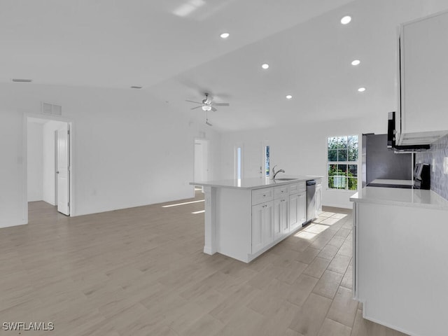 kitchen featuring light countertops, visible vents, open floor plan, white cabinets, and dishwasher