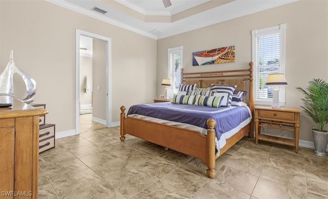 bedroom with ornamental molding, a tray ceiling, visible vents, and baseboards