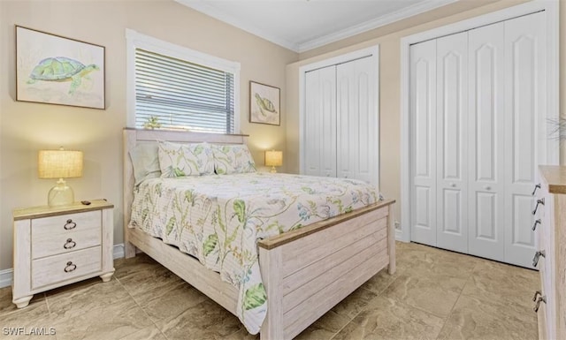 bedroom featuring baseboards, two closets, and crown molding