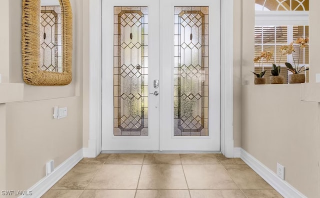 entrance foyer with french doors, tile patterned flooring, and baseboards