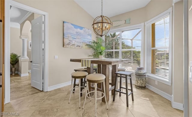 dining space featuring arched walkways, vaulted ceiling, baseboards, and an inviting chandelier