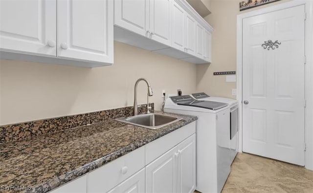 laundry room with cabinet space, separate washer and dryer, and a sink