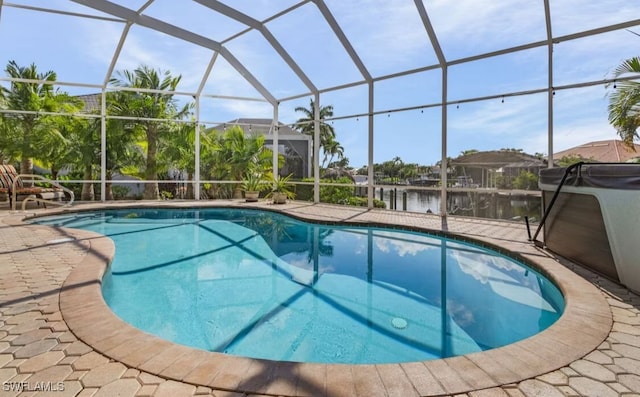 outdoor pool with glass enclosure and a patio area