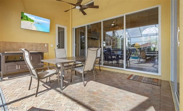 sunroom / solarium with a ceiling fan