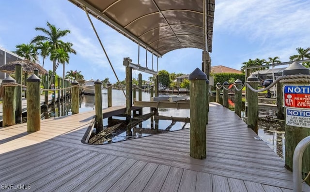 view of dock featuring a water view and boat lift