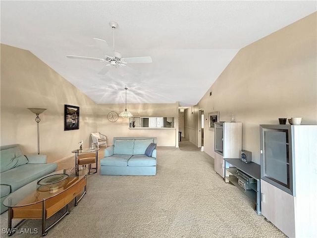 living area with a ceiling fan, light carpet, high vaulted ceiling, and baseboards