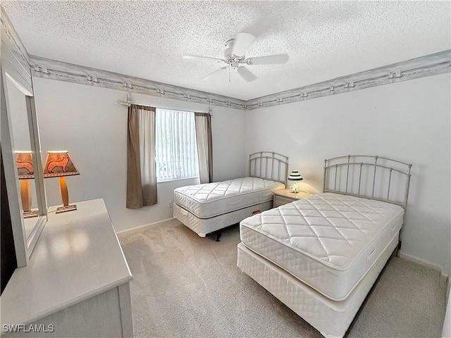 bedroom featuring ceiling fan, a textured ceiling, and carpet flooring