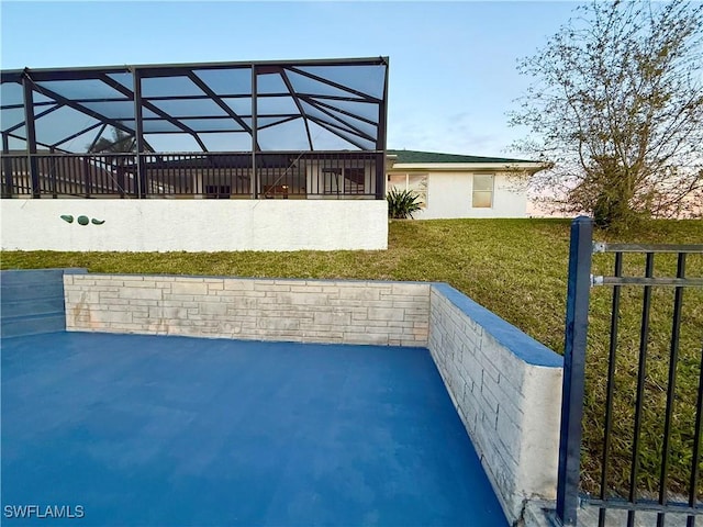 view of patio / terrace featuring a lanai and fence