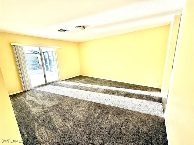 carpeted empty room with visible vents and baseboards