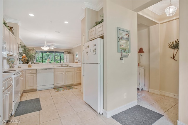 kitchen with light countertops, white appliances, a sink, and crown molding