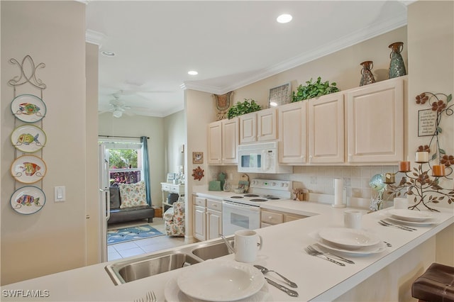 kitchen with crown molding, tasteful backsplash, light countertops, a sink, and white appliances