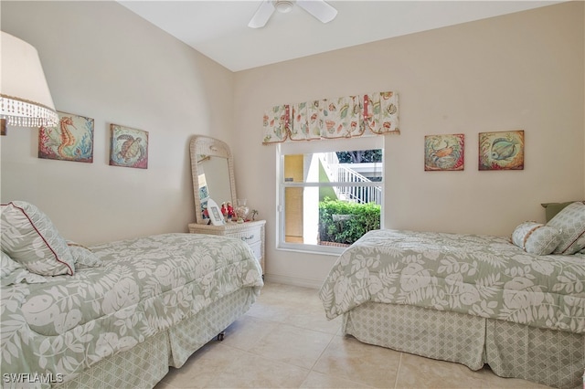 bedroom featuring tile patterned flooring, baseboards, and a ceiling fan