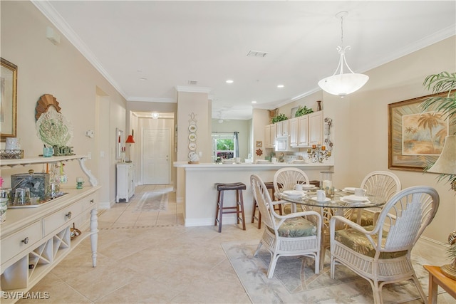 dining space featuring baseboards, visible vents, crown molding, and light tile patterned flooring