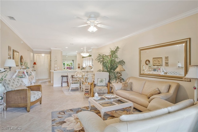 living area with light tile patterned floors, ceiling fan, ornamental molding, and visible vents