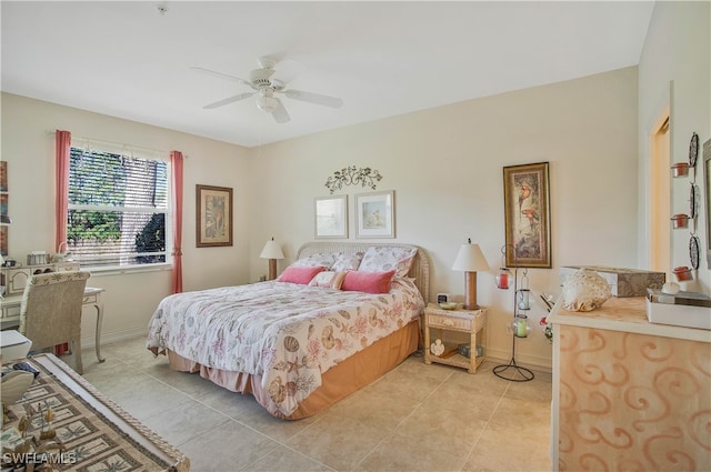 bedroom with light tile patterned floors, ceiling fan, and baseboards