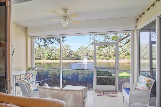 sunroom featuring a wealth of natural light, a water view, and ceiling fan