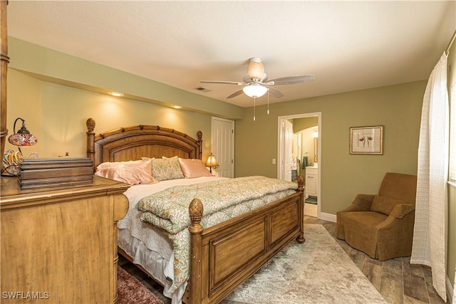 bedroom with visible vents, baseboards, light wood finished floors, ensuite bath, and ceiling fan