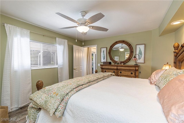 bedroom featuring wood finished floors and a ceiling fan