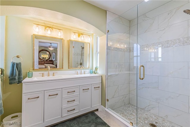 ensuite bathroom with a sink, ensuite bathroom, double vanity, and a shower stall