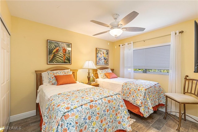 bedroom with baseboards, a closet, and ceiling fan