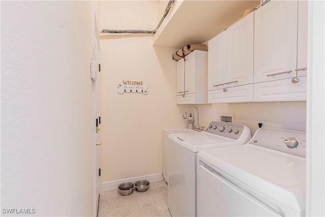 clothes washing area featuring washer and clothes dryer, a sink, cabinet space, light tile patterned flooring, and baseboards