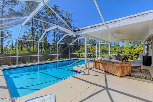 view of swimming pool featuring a patio, fence, glass enclosure, a fenced in pool, and ceiling fan