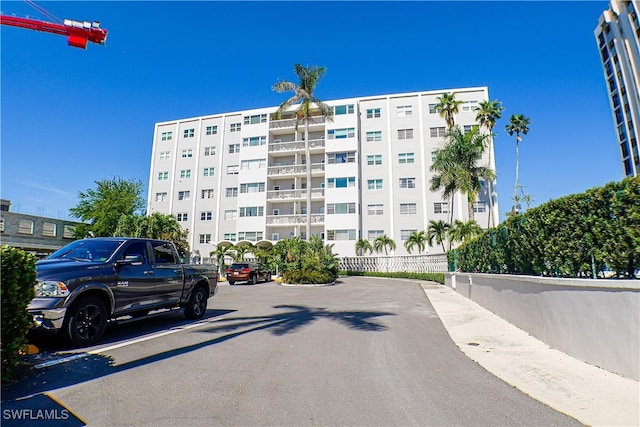 1900 Clifford St Unit 603, Fort Myers, FL 33901 - view of building exterior with fence and uncovered parking