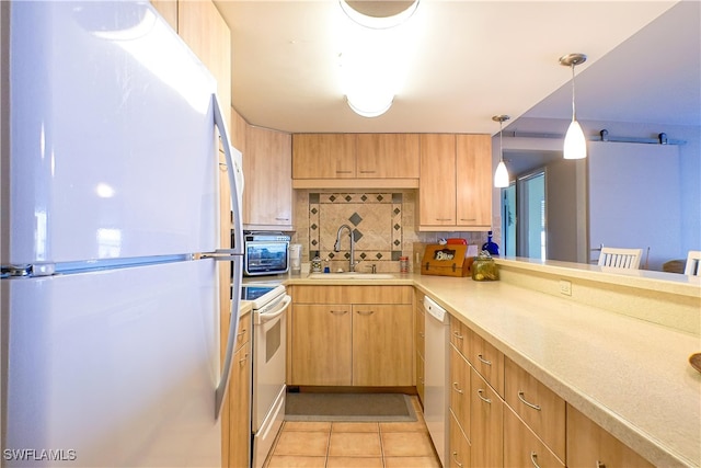 kitchen with white appliances, light tile patterned flooring, a sink, light countertops, and backsplash