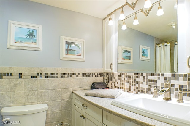 bathroom featuring vanity, tile walls, toilet, and a shower with curtain