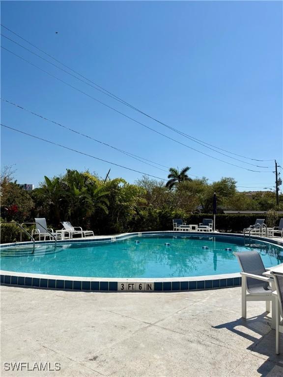 community pool featuring a patio area