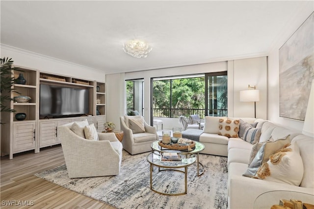 living room featuring crown molding and wood finished floors