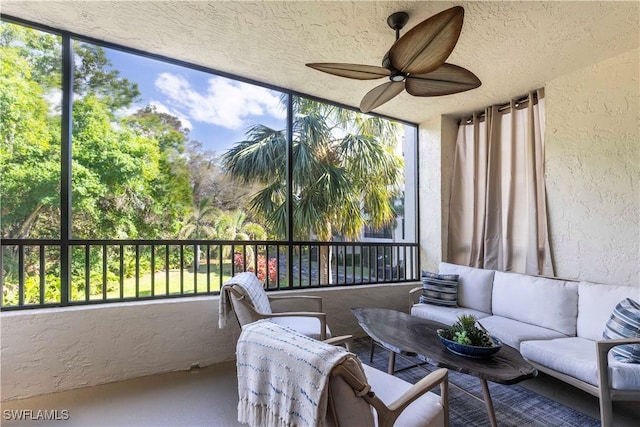 sunroom / solarium with a ceiling fan and a wealth of natural light