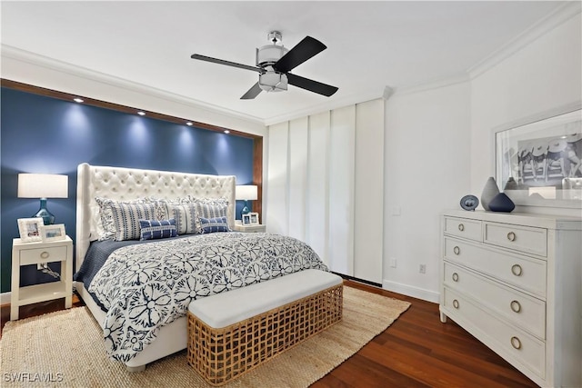 bedroom with ornamental molding, dark wood-style flooring, a ceiling fan, and baseboards