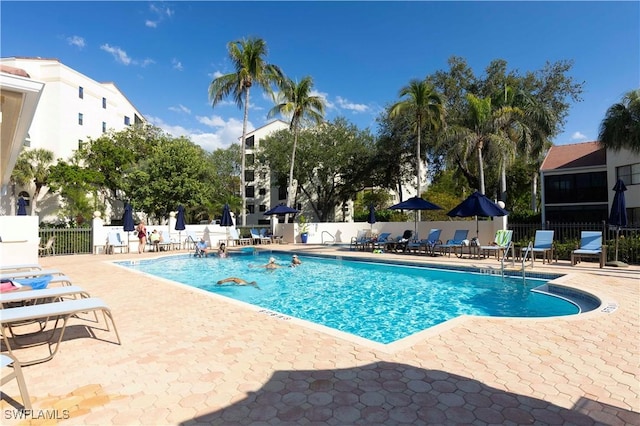 pool featuring a patio and fence