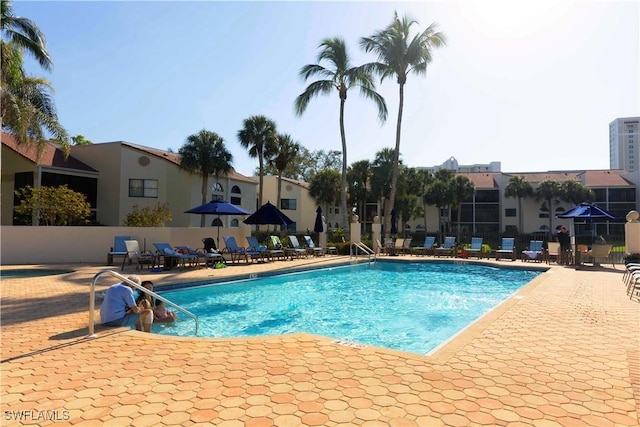 community pool featuring a patio and fence