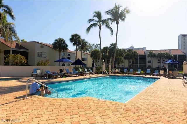 pool featuring a patio and fence