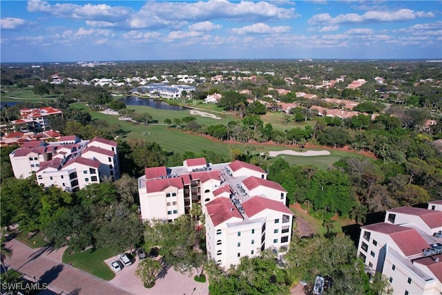 drone / aerial view featuring golf course view and a water view