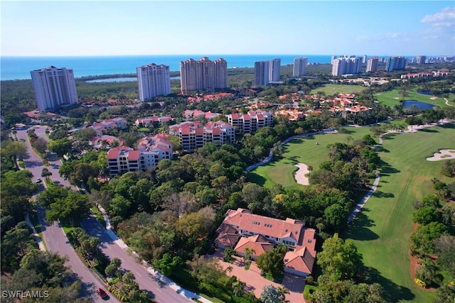 drone / aerial view featuring a view of city, golf course view, and a water view