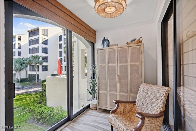 entryway featuring light wood-style flooring, arched walkways, and a wealth of natural light