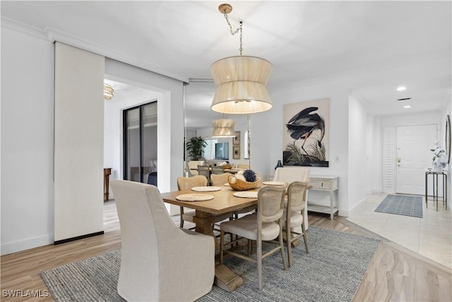 dining room with ornamental molding, recessed lighting, and baseboards