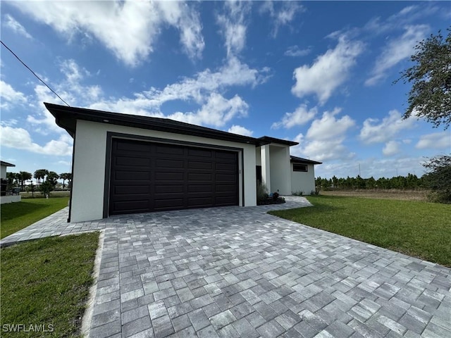 garage with decorative driveway