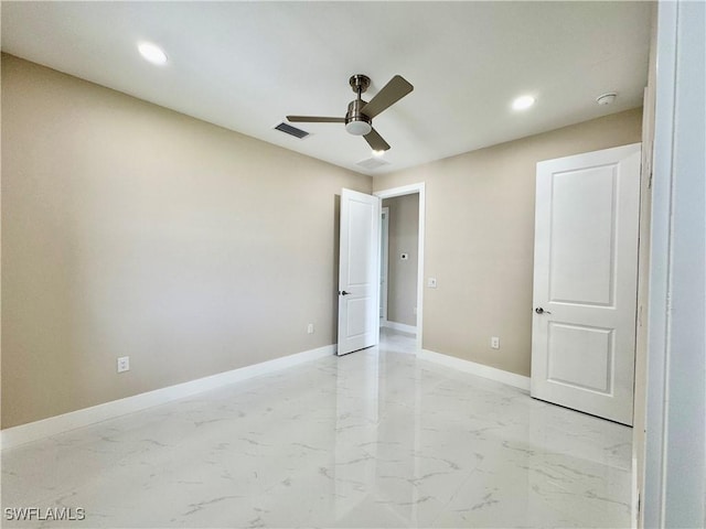 unfurnished bedroom with recessed lighting, marble finish floor, visible vents, and baseboards