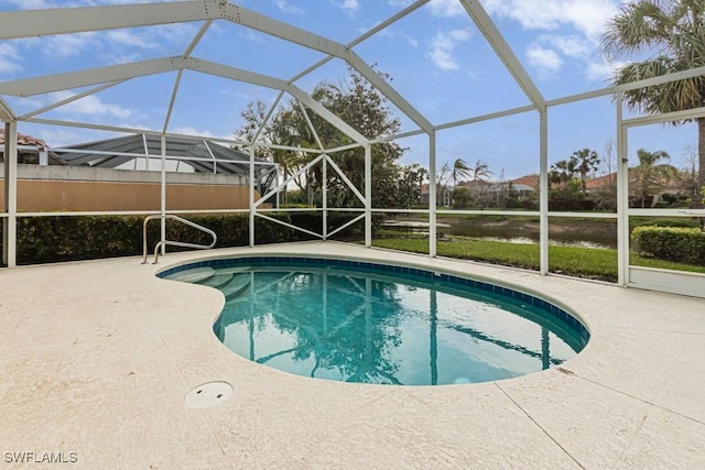 outdoor pool featuring a patio area and glass enclosure