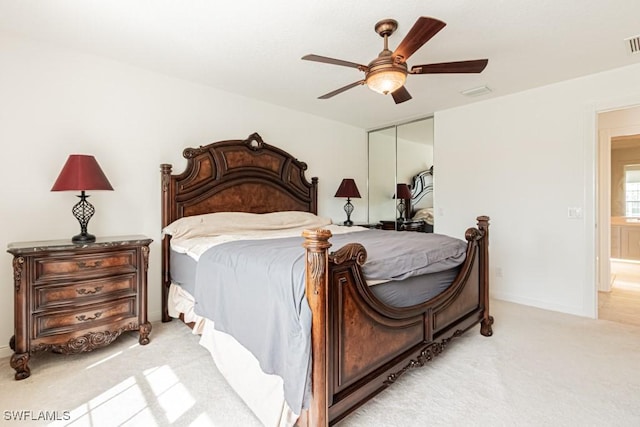 bedroom featuring visible vents, light carpet, a closet, baseboards, and ceiling fan