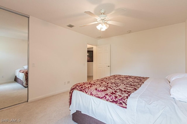 carpeted bedroom with visible vents, ceiling fan, and baseboards