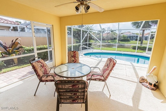 sunroom / solarium featuring a pool, a healthy amount of sunlight, and ceiling fan