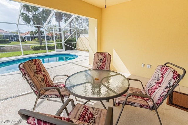 outdoor pool with a patio area, a lanai, and outdoor dining area