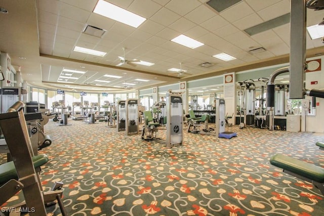 exercise room featuring a paneled ceiling, carpet floors, and visible vents