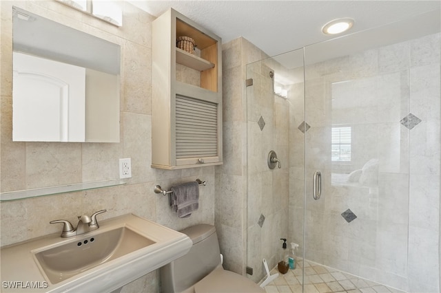 6891 Estero Blvd Unit 362, Fort Myers Beach, FL 33931 - bathroom with tile walls, toilet, a stall shower, and a sink